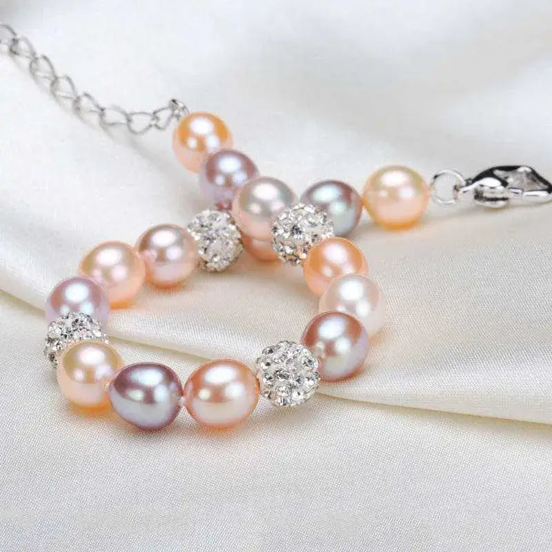 Pearl bracelet with silver beads on a white fabric background