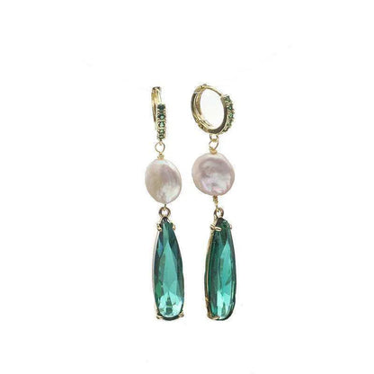 Pair of earrings with green teardrop stones and pearl-like tops on a white background