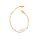 Gold bracelet with a pearl accent on a white background