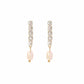 Pair of earrings with crystal accents and pearl drops on a white background