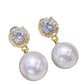 Pearl and crystal earrings on a white background