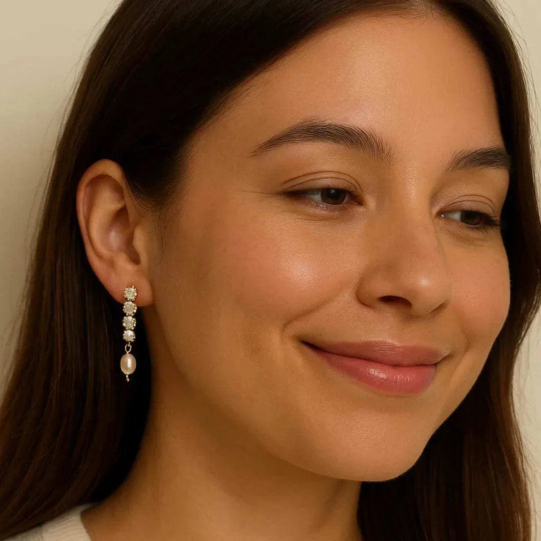 Close-up of a woman wearing earrings with a neutral background