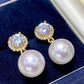 Pearl earrings with gold and diamond accents on a blue cushion