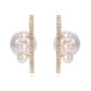 Pair of pearl earrings with gold and crystal accents on a white background
